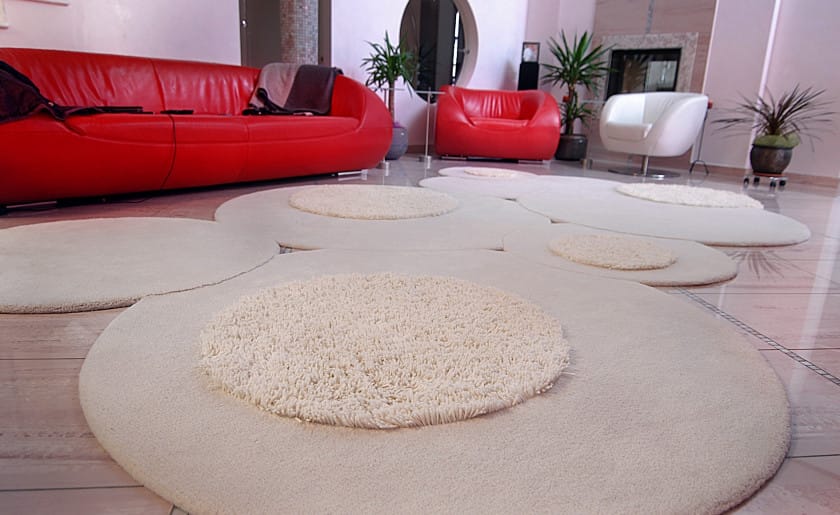 Stylish Custom Rug for Living Room is Custom circular rug in living room with red sofa and contemporary decor